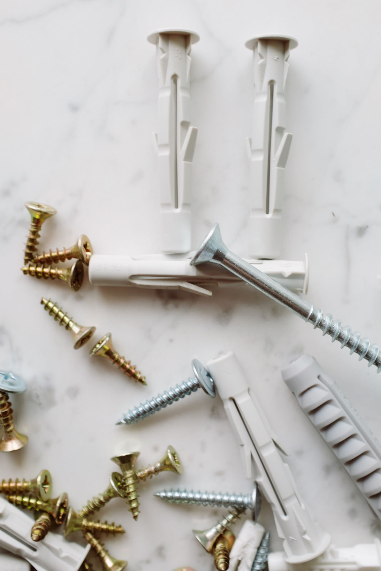 Fasteners and hardware laid out on marble for installation
